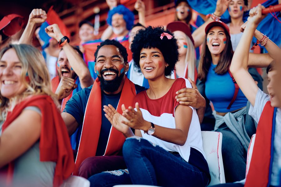 Booster club fans cheering at a game
